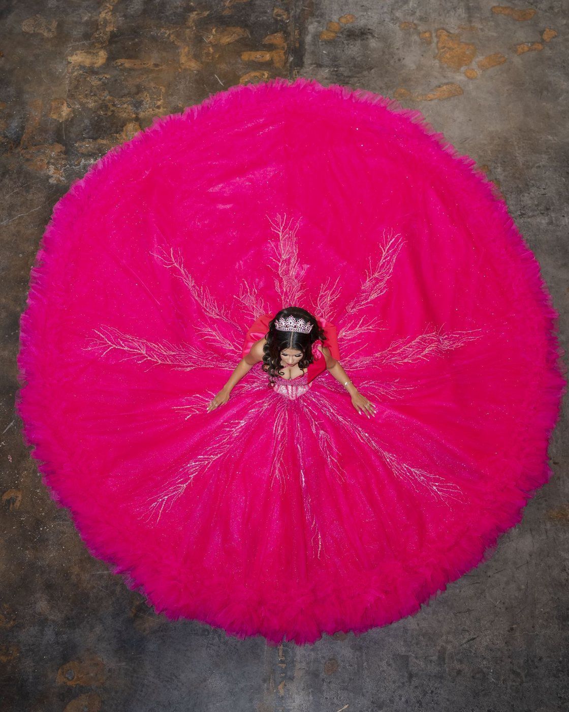 Overhead portrait of a quinceañera in a pink ball gown