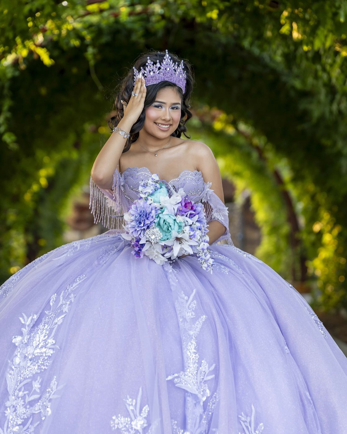 Quinceañera in lavender under a garden arch